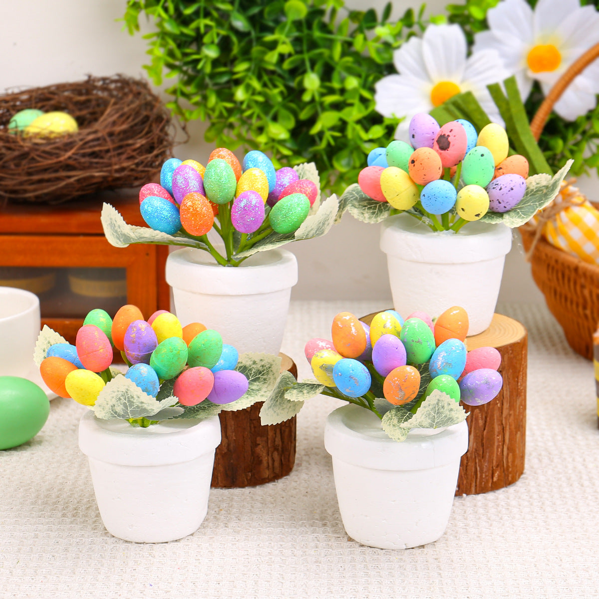 A white pot filled with artificial green leaves and vibrant, multicolored speckled eggs arranged in a floral shape, placed on a table with a festive background.