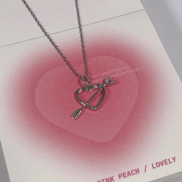 Heart and arrow pendant necklace displayed on card with pink gradient heart design and 'LOVELY' text