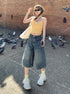 Front view, full-body shot – Wide-leg knee-length denim shorts in vintage blue, styled for streetwear.