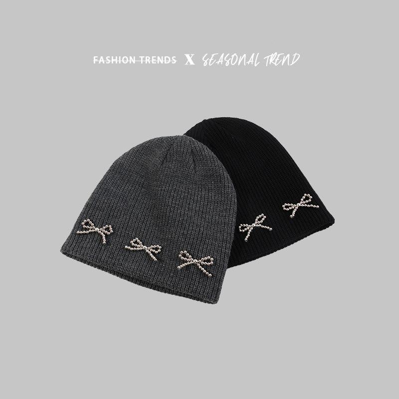 Gray and black knit beanies with pearl-studded bow decorations, displayed with "Fashion Trends X Seasonal Trend" text