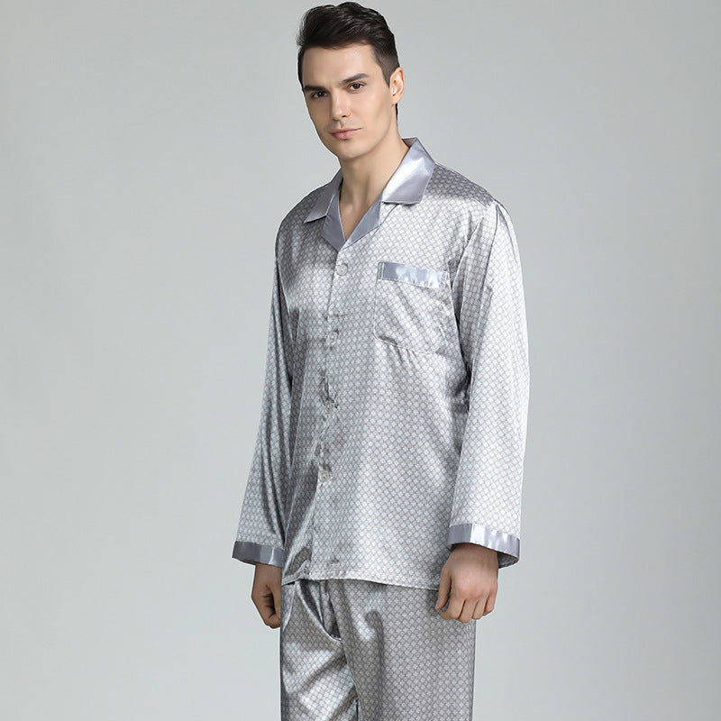 Model wearing silver silk pajamas with diamond pattern, button-up top, standing against gray background