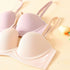 Two seamless padded bras in medium nude and pink, featuring soft underwire support and breathable fabric, displayed on a pastel background with a tulip.