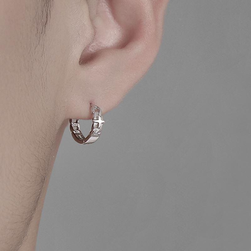 Chain-design silver hoop earring worn on ear, side profile.