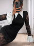 A woman wearing a black lace midi dress with a white pointed collar and flared cuffs, taking a mirror selfie while sitting on the floor.