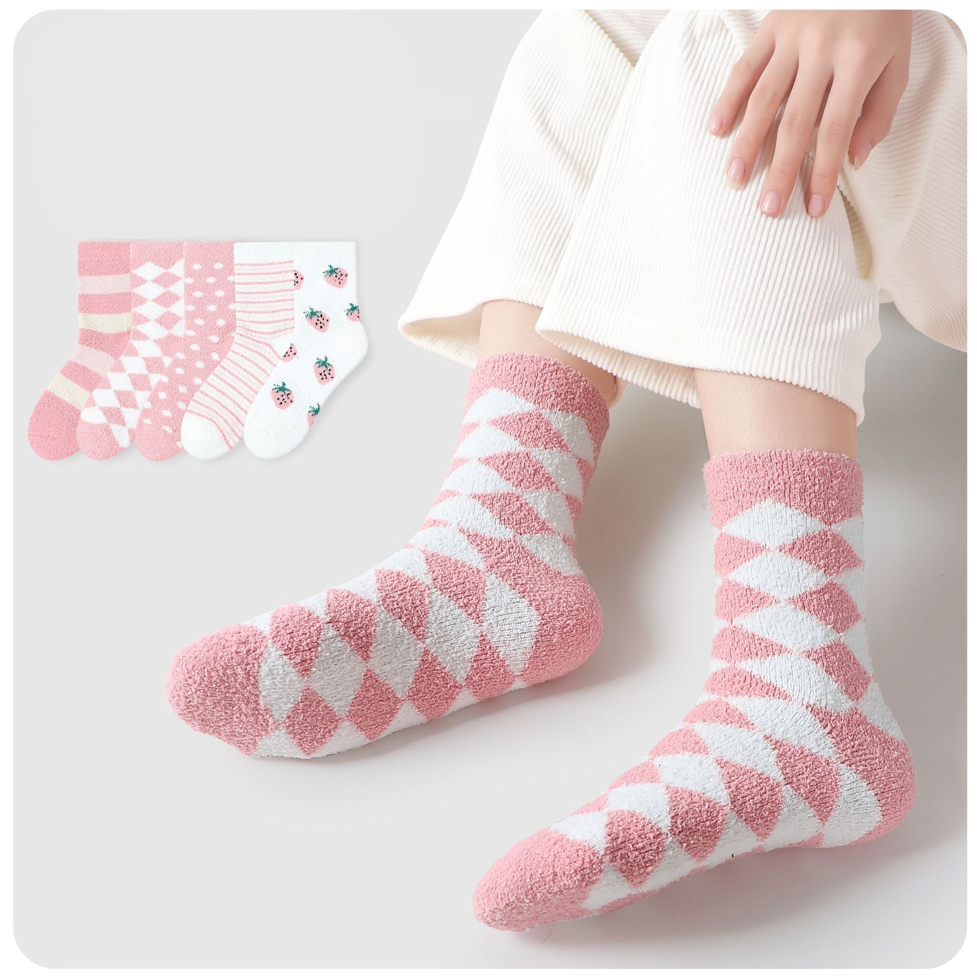 Collection of pink and white fuzzy socks in various patterns, including argyle, polka dots, stripes and strawberry prints