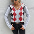 A woman wearing argyle cardigan in gray with red diamonds, styled with sunglasses, gold jewelry and black jeans