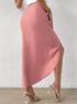 Side view of pink satin midi skirt with high slit and clear glass heel mules, showcasing draped fabric detail