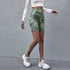 Model walks in green tie-dye ribbed biker shorts and a white cropped top, styled with platform sneakers