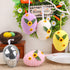 Hanging Easter eggs in pastel colors (purple, white, yellow, and pink) with sunflower and leaf decorations, each measuring 13cm x 10cm.