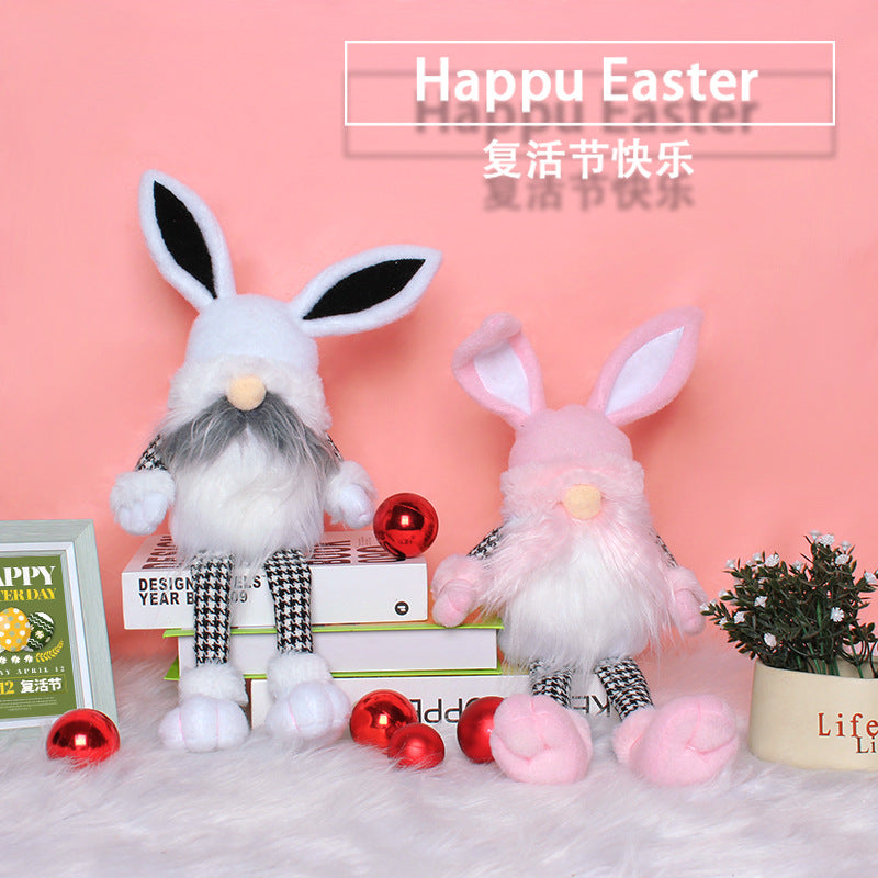 White and pink bunny gnome plushies with houndstooth legs sitting on books against a pink background with Easter decorations.