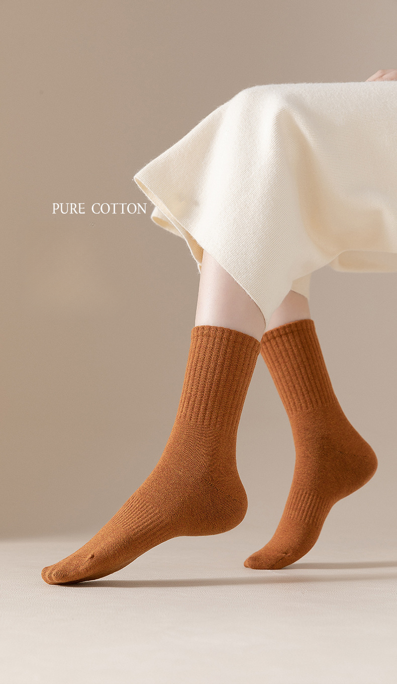 Camel brown cotton socks displayed against white fabric with 'Pure Cotton' text overlay