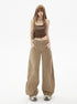 Front view of woman wears high-waisted khaki wide-leg jeans with front seam detail.
