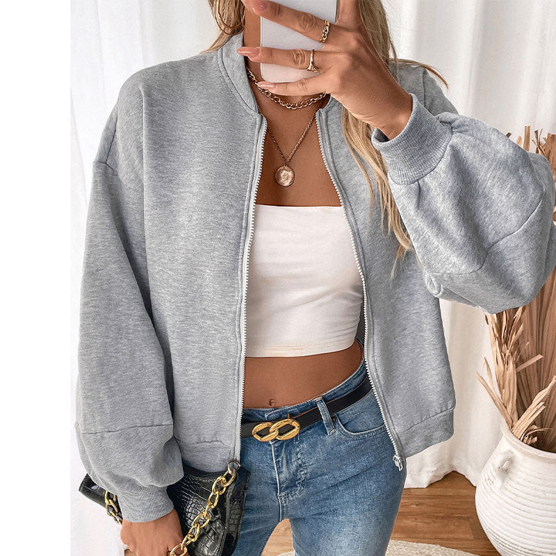 Gray zip-up jacket, model styling with layered gold necklaces and white tube top