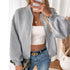 Gray zip-up jacket, model styling with layered gold necklaces and white tube top