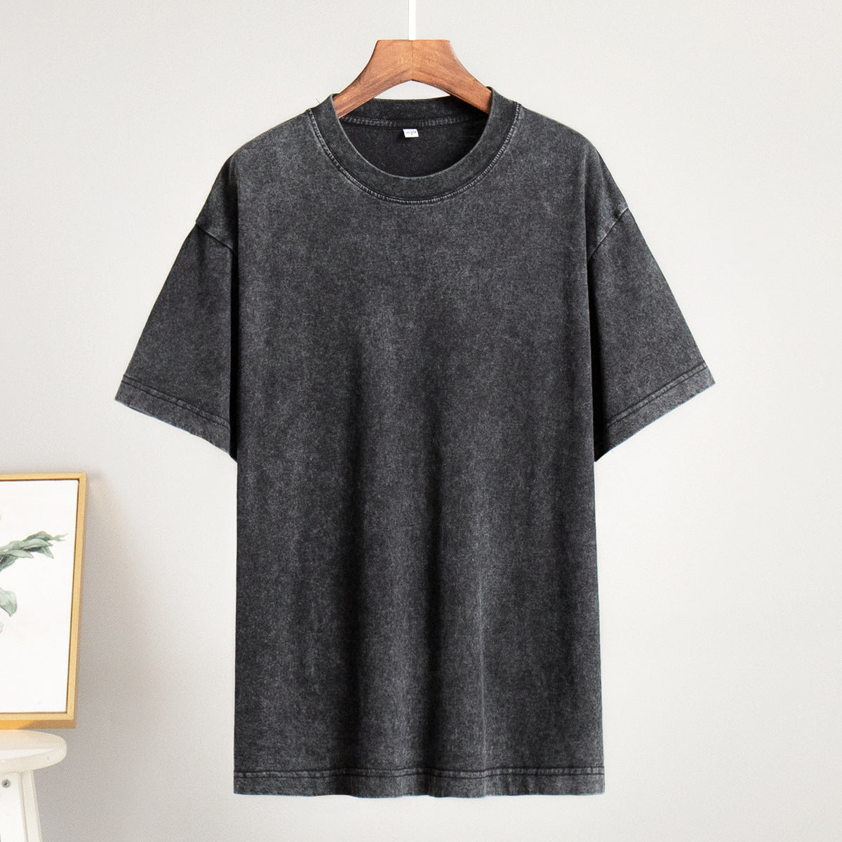 Gray t-shirt on a hanger against a white background