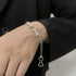 Silver dog bone chain bracelet on wrist