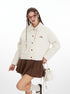 Woman wearing a white jacket with red buttons and a brown skirt on a white background