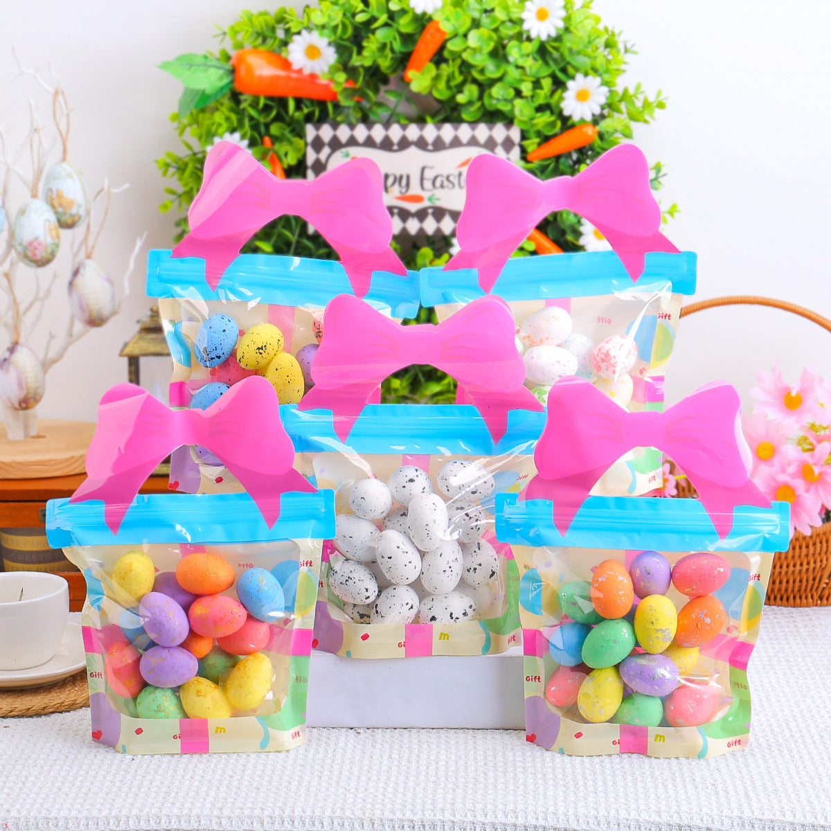 Transparent gift bags filled with colorful speckled eggs, featuring pink bow handles, set against a festive Easter backdrop.