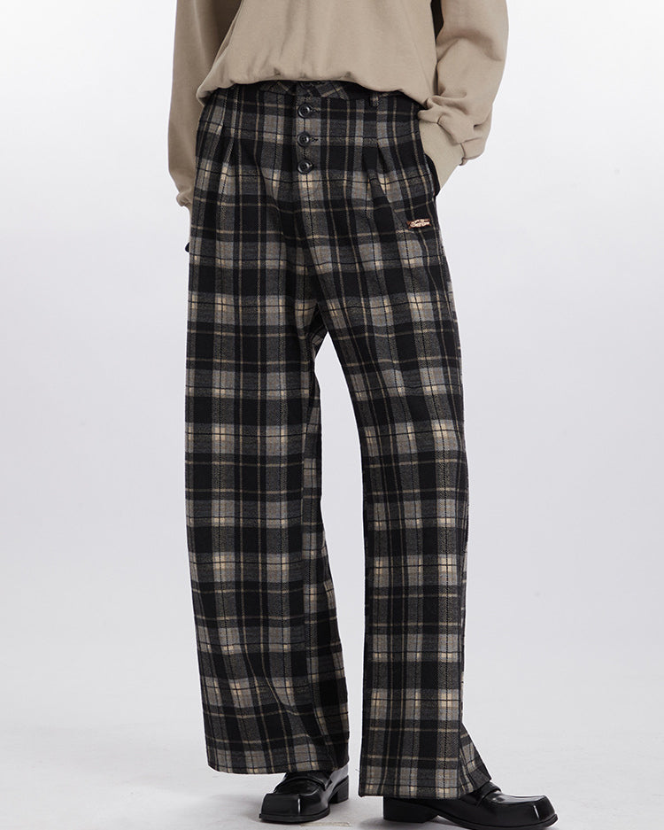 Wide-leg plaid pants in black and gray with button front and metal brand tag