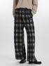 Wide-leg plaid pants in black and gray with button front and metal brand tag