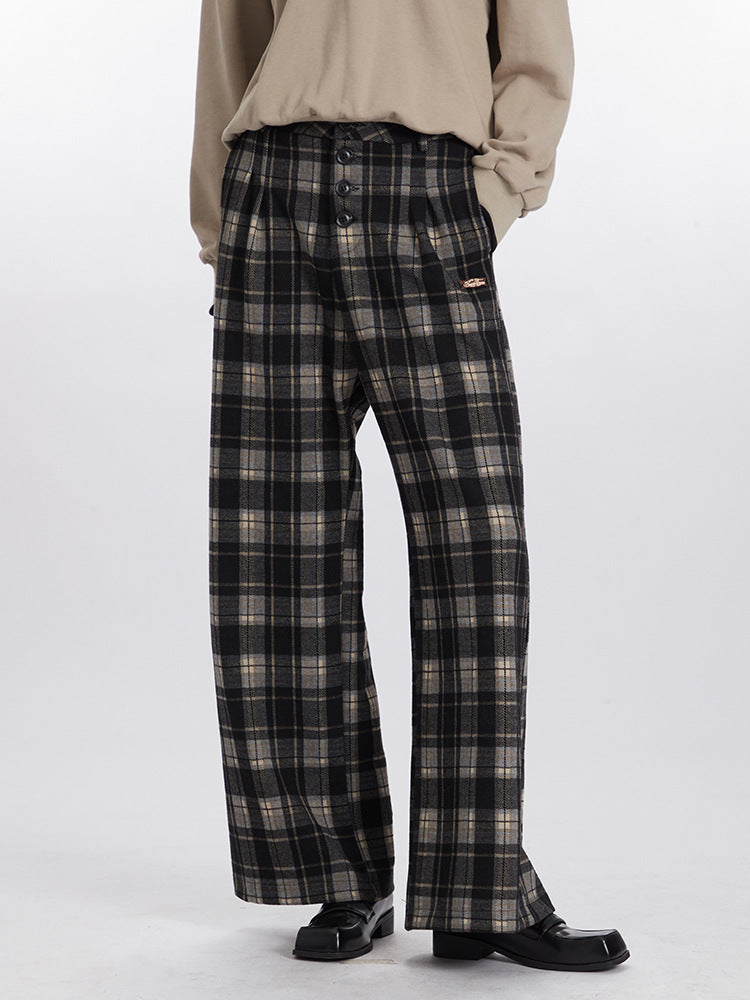 Wide-leg plaid pants in black and gray with button front and metal brand tag