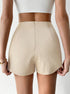 Back view of cream textured high-waisted skort showing tailored fit and hidden zipper closure, styled with white crop top