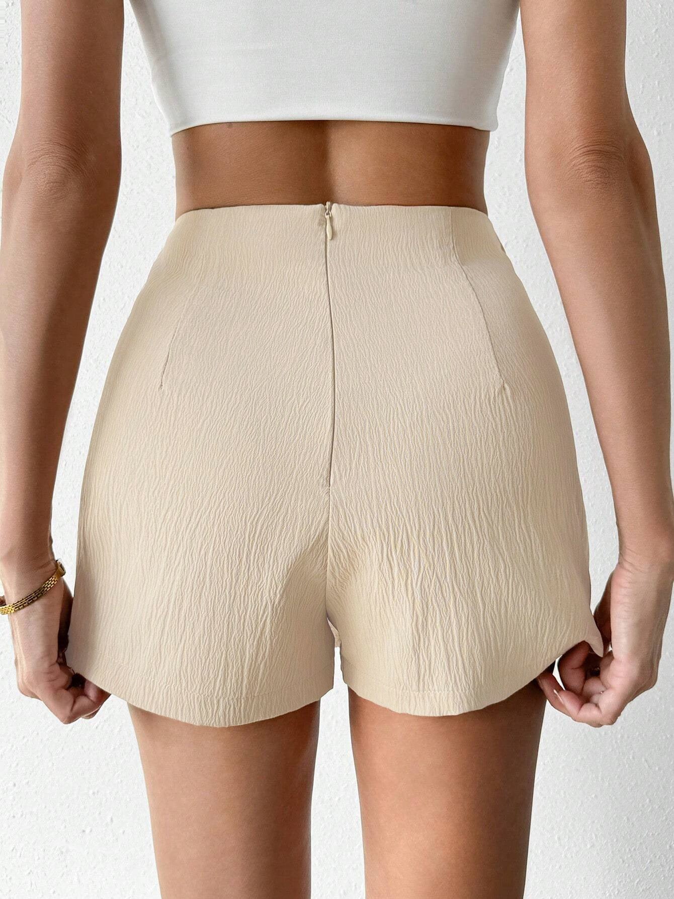 Back view of cream textured high-waisted skort showing tailored fit and hidden zipper closure, styled with white crop top