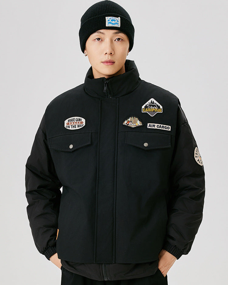 Black winter jacket with camping-themed patches, featuring high collar, multiple pockets and Air Cargo branding with Brave Game patch