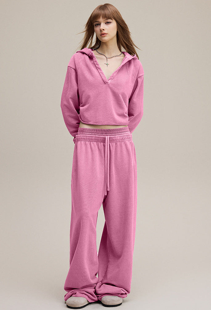 Model front view in rose pink cropped hoodie—streetwear hot-girl crop.