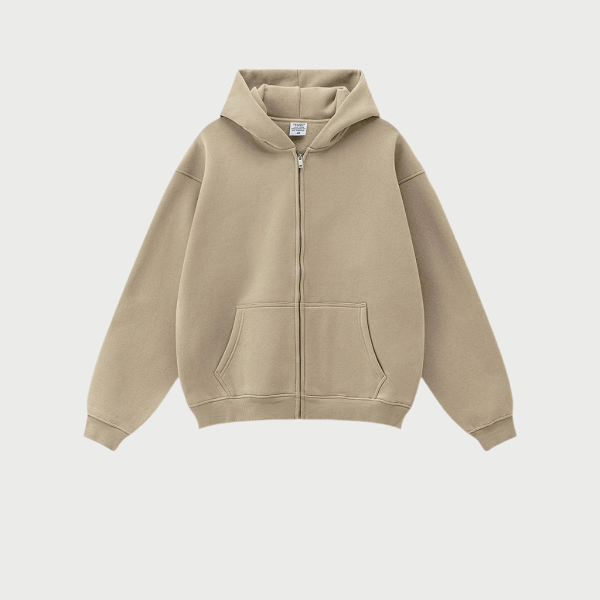Beige oversized zip-up hoodie with front kangaroo pocket and ribbed cuffs displayed on light gray background