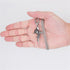 A hand holding silver rose cross pendant necklace with vine detail and sturdy box chain against white background