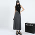 Full-length shot showing charcoal gray pleated maxi skirt with ankle-length hem and tailored waistband