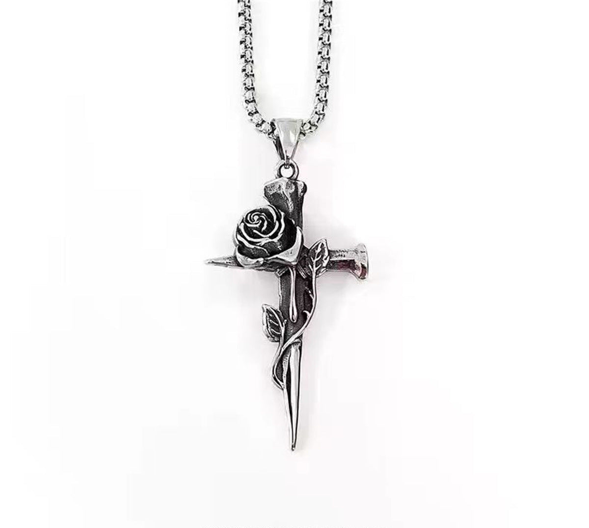 Silver rose cross pendant featuring detailed flower bloom and stem design on box chain against white background