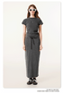 Dark gray long denim skirt and matching short-sleeve top, with white bow-tied sneakers and oversized white sunglasses