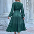 A model is showing the back view of forest green tiered maxi dress with elegant ruffle hem, self-tie waist belt and blouson sleeves