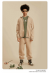 Man in beige zip-up hoodie with olive shirt, matching sweatpants and gold-rimmed sunglasses.gif