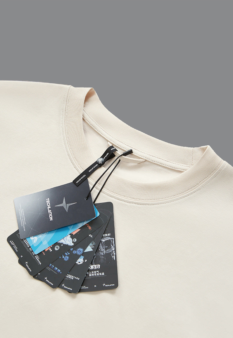 Flat lay of cotton tee with hang tag, minimal streetwear branding