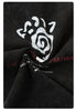 Close-up of the black T-shirt fabric twisted to reveal a white and red distressed graphic print