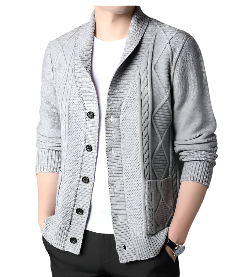 Front view of light gray cable knit cardigan showing button-front design, patch pockets, and ribbed trim on a mannequin with white t-shirt underneath