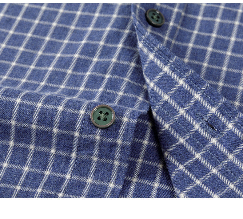 Macro detail of button and buttonhole on blue check shirt with precise reinforced stitching