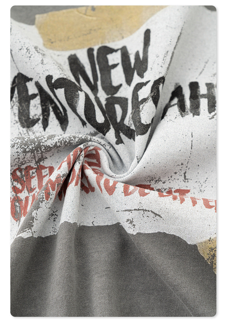 Close-up of "New Adventures Ahead" graphic print showing distressed vintage-style printing technique