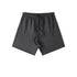 Black cotton shorts with elastic waistband and front drawstring ties, displayed against white background