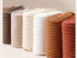 Artfully rolled pure cotton socks in neutral tones from brown to white arranged in a row