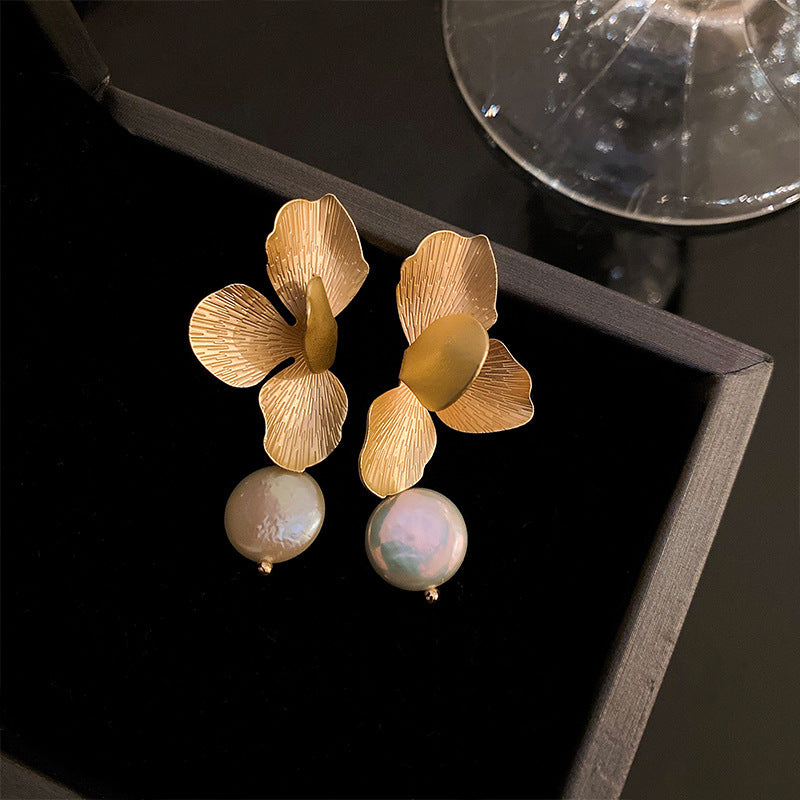 Floral Gold and Pearl Drop Earrings – Gold flower-shaped earrings with delicate textured petals and dangling pearl accents