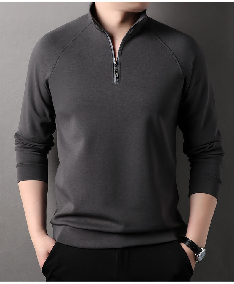 Charcoal gray quarter-zip pullover sweater with standing collar and raglan sleeves, styled with black pants and wristwatch