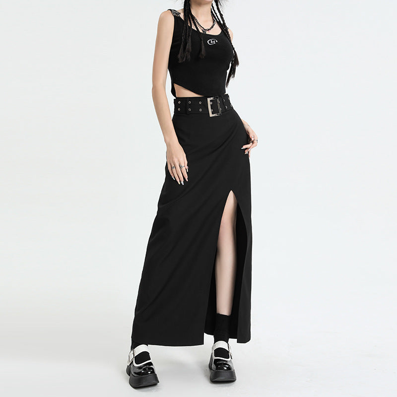Black maxi skirt with side slit and wide studded belt, paired with crop top and platform mary janes on white background