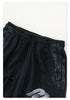 Detail of black sweatpants waistband with drawstring and distressed print