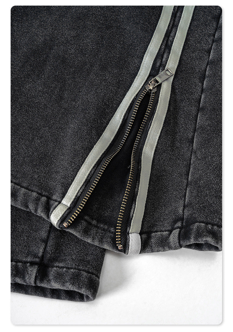 Fabric texture close-up of black denim track pants showing soft washed finish and comfortable material