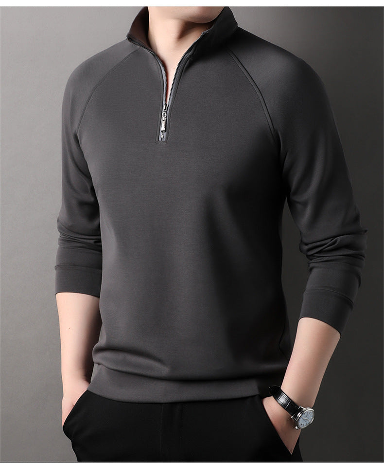 Dark gray quarter-zip pullover sweater with standing collar and silver zipper pull, worn with black pants and wristwatch