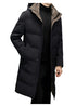 A man with one hand in his pocket wearing a black long puffer coat with a front snap closure and a high-neck hood